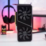 Close-up product-style photo of a dual-fan NVIDIA GeForce RTX graphics card standing vertically on a desk, with a PC setup background—ideal for GPU pricing, used GPU buying guides, and PC hardware articles.